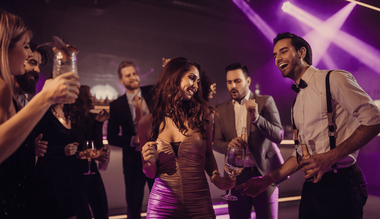 At a party a woman is dancing and a group of men looking at her